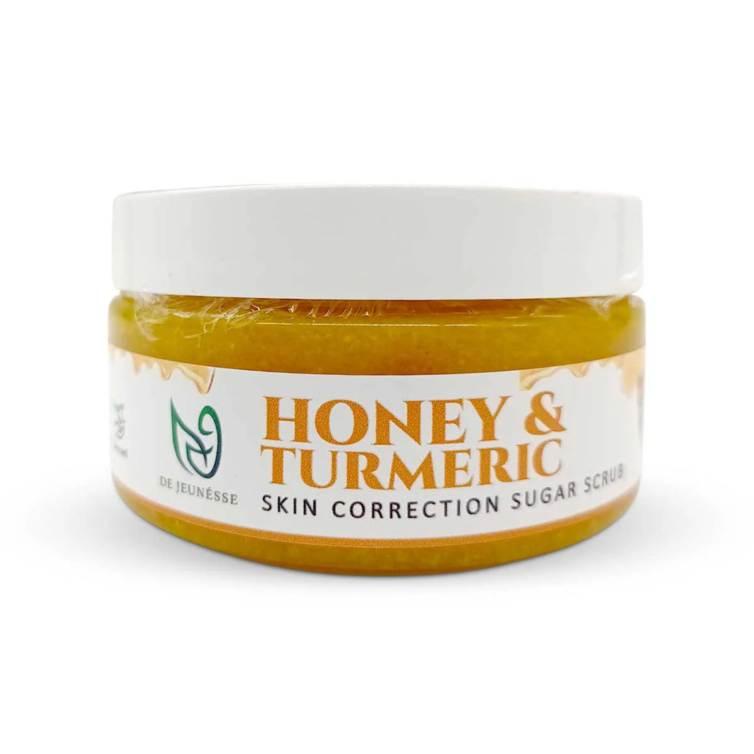 Jar of honey and turmeric skin correction sugar scrub with a white label on a white background