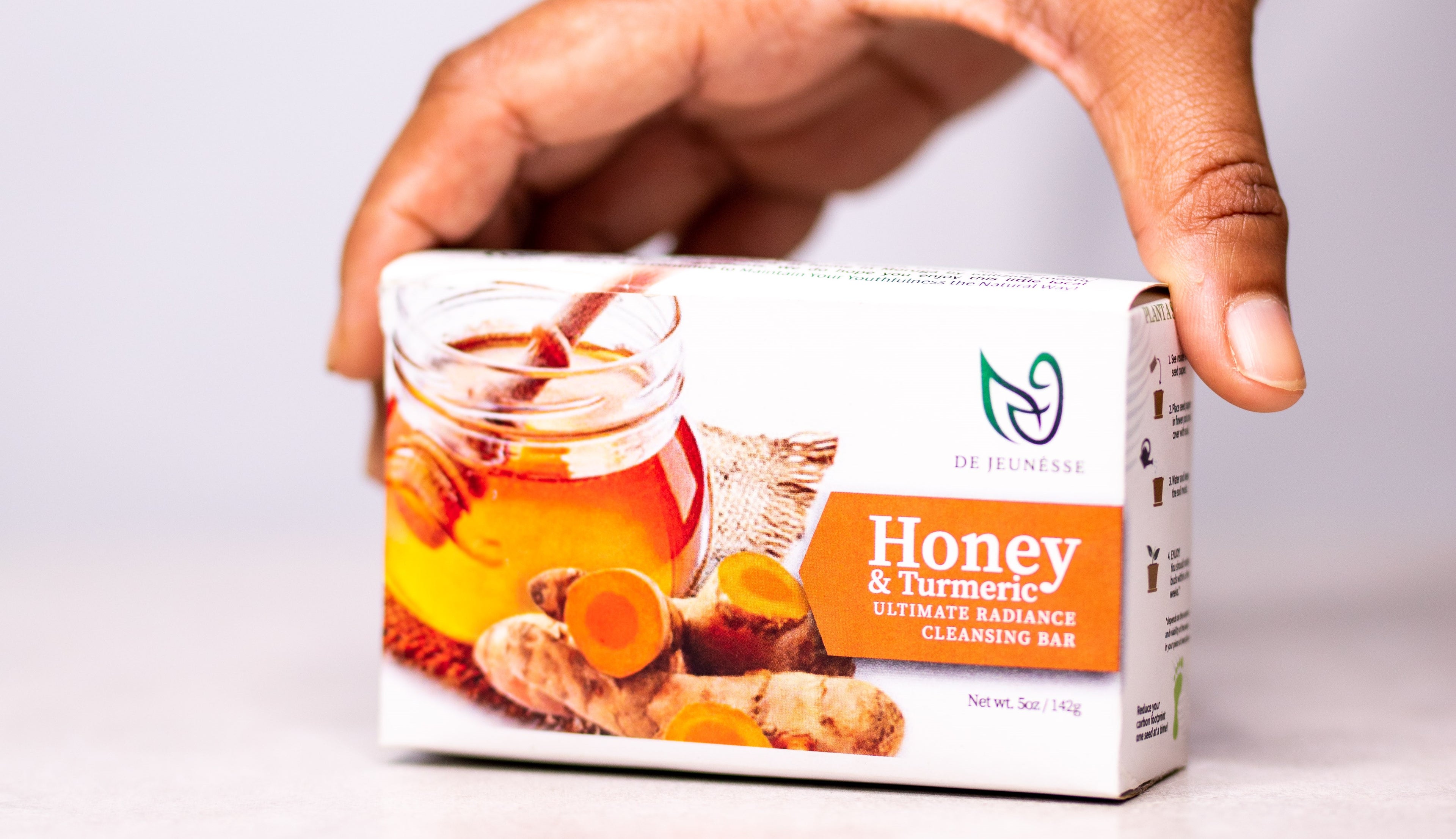 woman holding a honey and turmeric soap