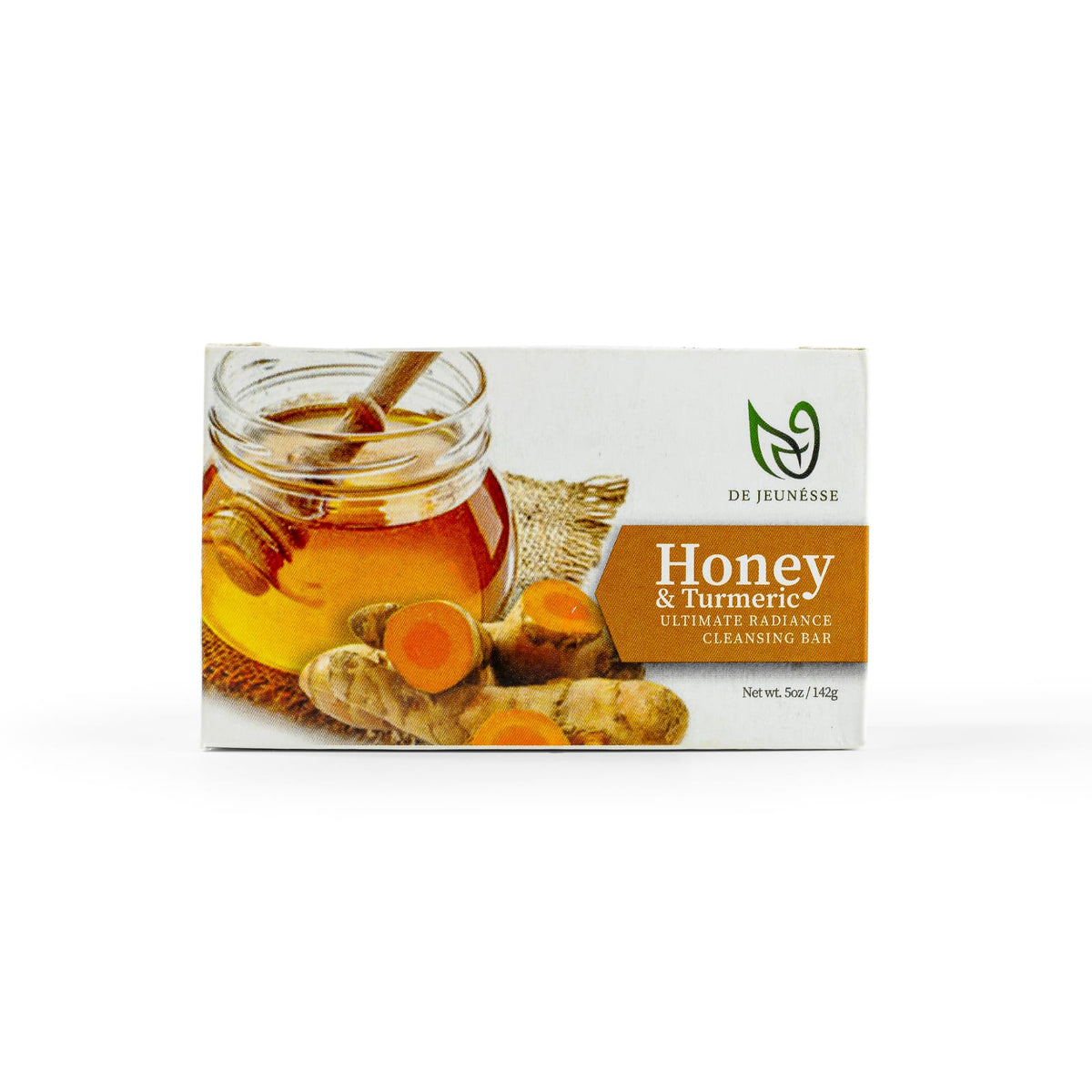 Packaged cleansing bar with honey and turmeric depicted on the front, with a clear jar of honey and fresh turmeric roots in the background.